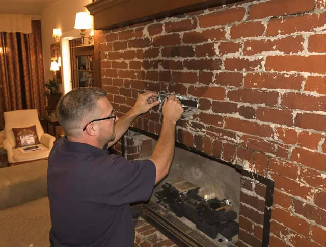 Shelton Chimney Sweep expert fixing a fireplace in Shelton, CT